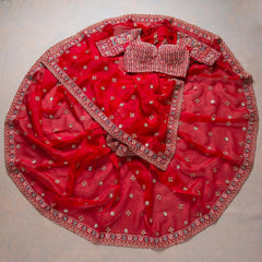Adorning Red Rangoli Silk Saree With Designer Fancy Readymade Blouse.